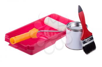 Pouring paint in a red plastic pan with roller isolated on white