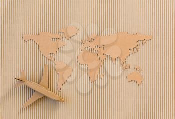 Airplane and world map made of cardboard. Worldwide delivery concept.