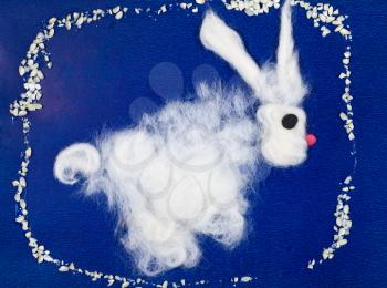 childs drawing - white fluffy bunny on blue background