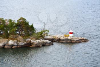 small beacon on stone island in swedish fiord