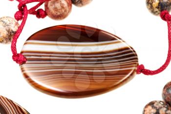 agate gemstone in lady's bead closeup isolated on white