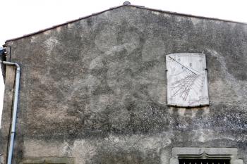 wall of medieval house with sun-clock in Nimes, France