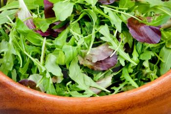 fresh salad mix in wooden bowl close up