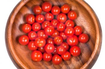 many red cherry tomatoes in wooden bowl