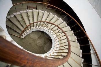 spiral stairs with wood handrail
