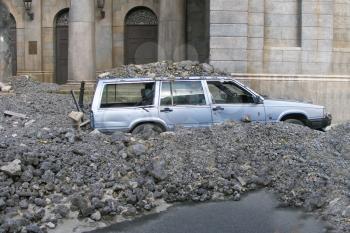 car under stones after earthquake