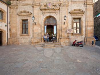 PIAZZA ARMERINA, SICILY - JUNE,29: old sicilian man in door of Palazzo di Citta in Piazza Armerina, Italy on June 29, 2011