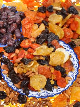 lot of sweet dried fruits on asian plates