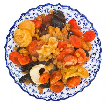 top view of dried fruits on turkish plate isolated on white background
