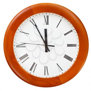 at five minutes to twelve o clock on round dial clock