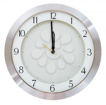 one minute to twelve o clock on the dial round wall clock