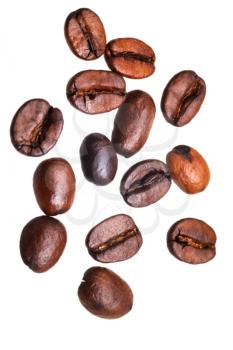 many falling roasted coffee beans isolated on white background