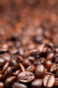 fresh roasted coffee beans background with focus foreground
