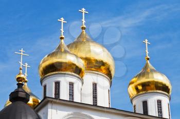 golden cupola of russian church Dormition Cathedral under blue sky in Dmitrov Kremlin, Russia