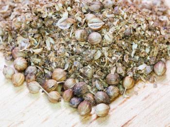 milled coriander and dried coriander seeds close up