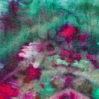 abstract stained green and magenta pattern of nodular batik painted on silk
