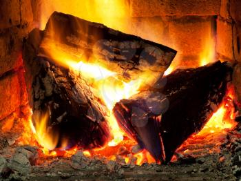 burning fuelwood in fireplace in evening time
