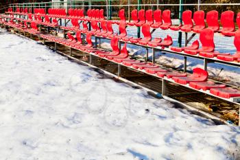 red broken plastic seats at sport field in low season