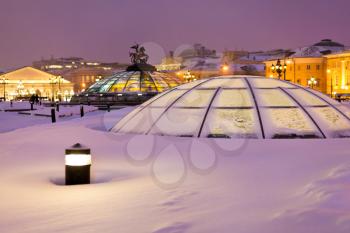 snow in Moscow - view of snow covered glass cupola on Manege square in winter snowing evening