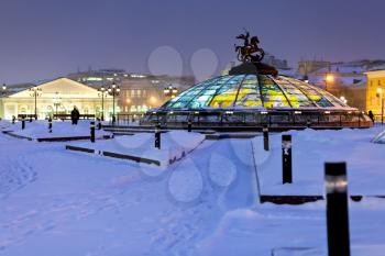 snow in Moscow - view of glass cupola on Manege square in winter snowing evening