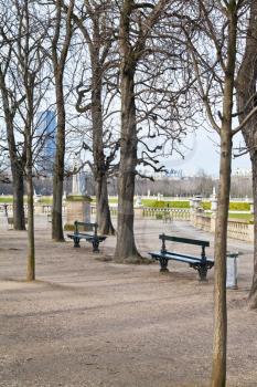 green wooden garden benches in Luxembourg Gardens in Paris in spring