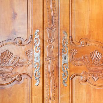 carved wooden door of old wardrobe