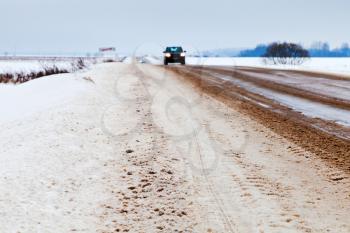 snowed country road in winter afternoon