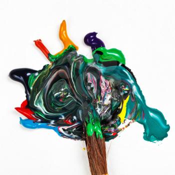 round paintbrush blends multicolored watercolor paints close up