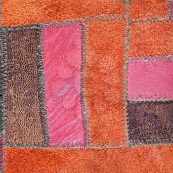 background from red and brown leather patchwork close up