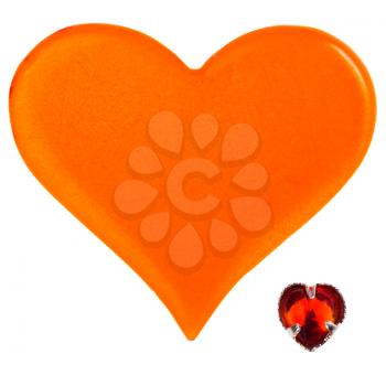 big orange plastic heart and small red glass heart isolated on white background