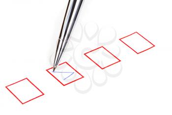 tick in red square box by silver metal pen