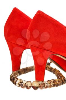 heels of woman red pumps shoe with necklace isolated on white background