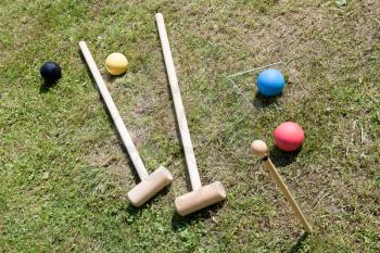 croquet equipment for game of croquet on green lawn in summer day