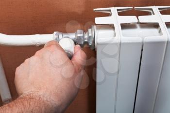 adjustment of thermostat of home heat radiator