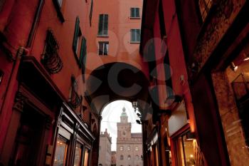 view on clock tower of Palazzo d'Accursio (Palazzo Comunale) from arch, Bologna, Italy