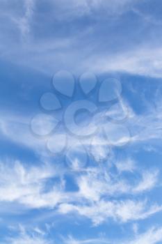 swirling small white clouds in italian blue sky in autumn