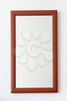 simple wall mirror in wooden brown frame