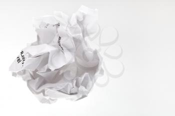 crumpled sheet of paper on grey background