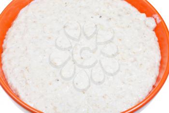 traditional english oat porridge with milk in bowl close up