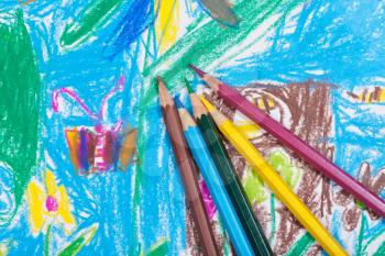 several colored pencils on children picture background