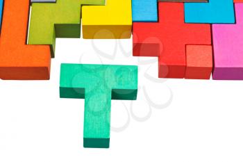 T-shaped block and wooden multicoloured puzzle isolated on white background