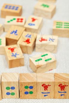 wood tiles closeup in mahjong game during playing on textile table
