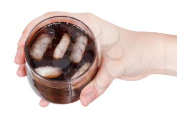 top view of hand holding cola with ice in glass isolated on white background