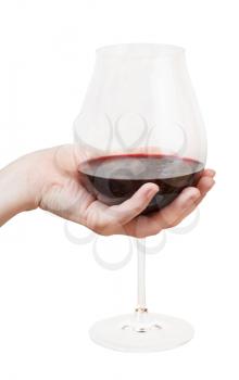 hand holds big glass with red wine isolated on white background