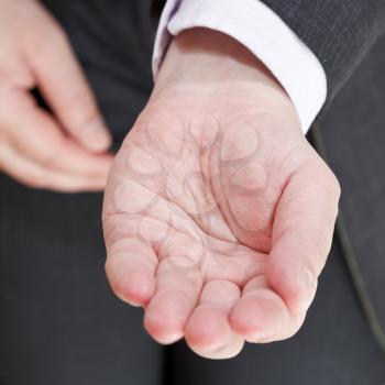 businessman holds empty handful close up - hand gesture