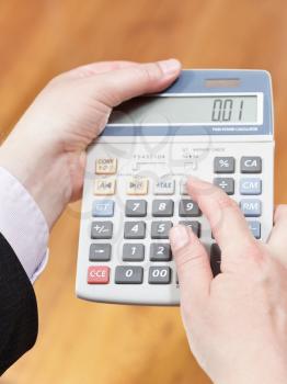 above view of calculator in businessman hands
