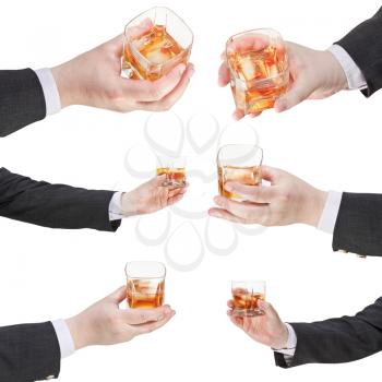 set of of whiskey with ice glass in businessman hand isolated on white background