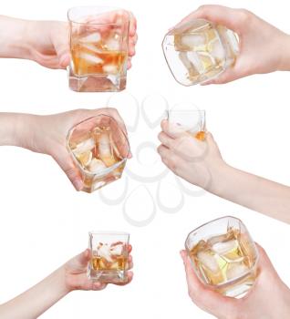 set of hand holds whiskey on ice in glass isolated on white background