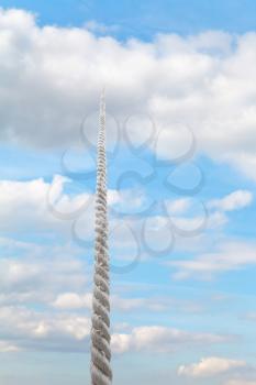 rope rises to white cloud in light blue sky