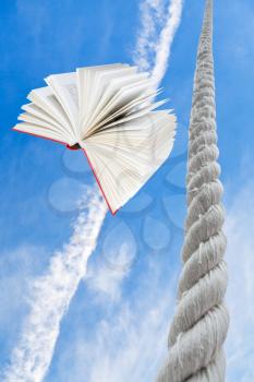 flying book and rope rises to blue sky with light white clouds